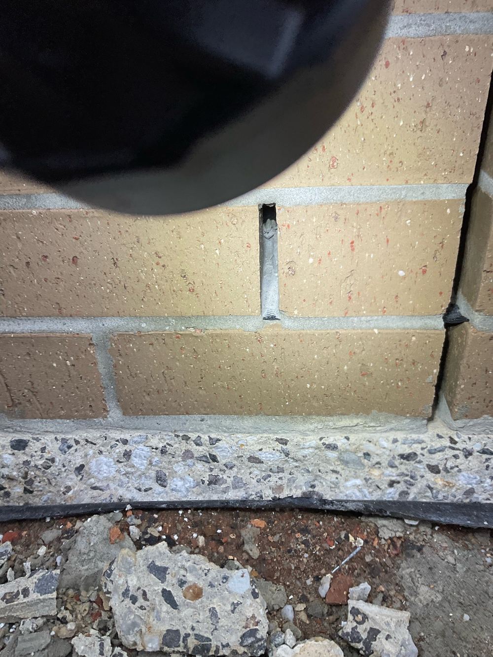 Weep holes blocked with mortar and render, trapping moisture in the wall, found during a fixing inspection in Strathtulloh