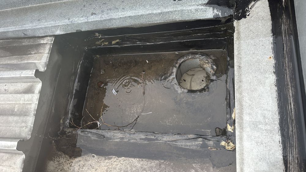 Gutter installed out of line with the flashing, wetting the fascia, found during a defect investigation inspection in Richmond