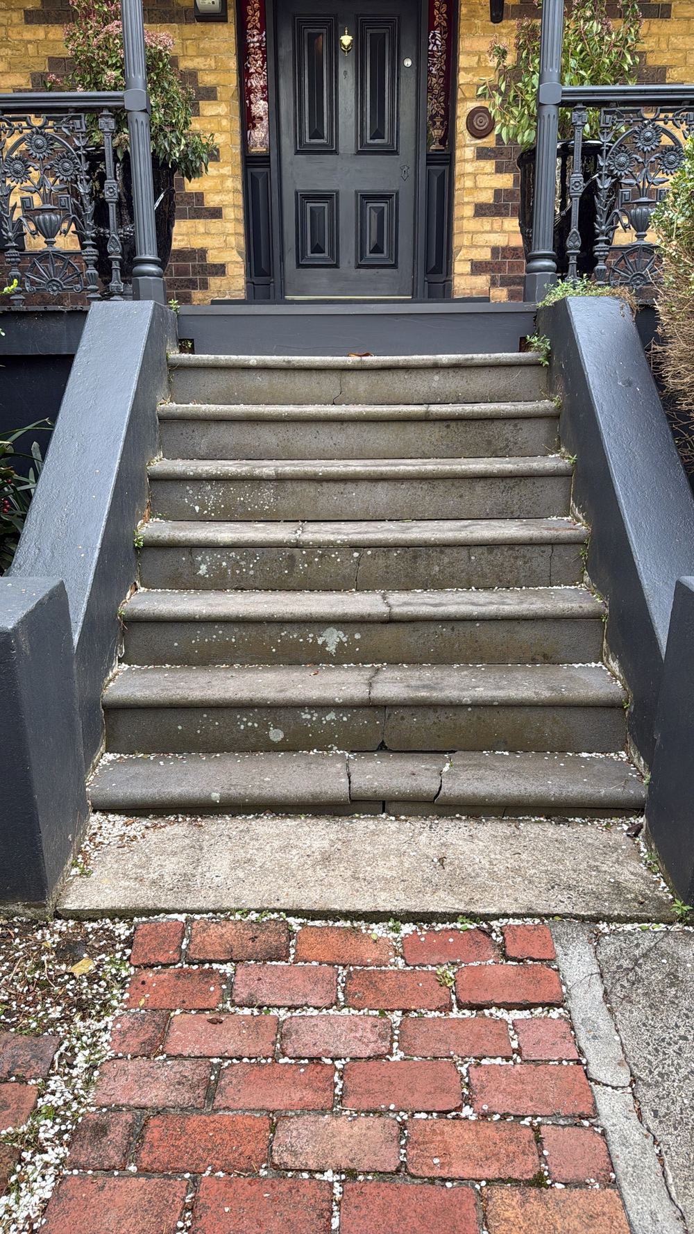 Outdoor steps with uneven riser heights that create a trip hazard, found during a pre-purchase inspection in Hawthorn
