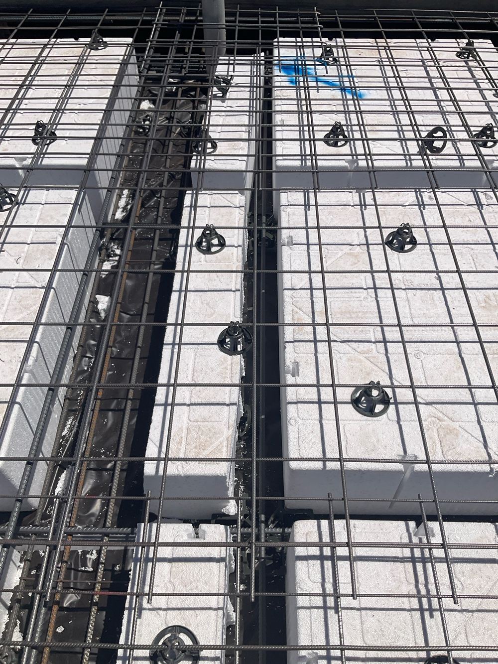 A waffle pod squeezing an internal beam to 30mm where 110mm was designed, found during a slab pre-pour inspection in Strathtulloh